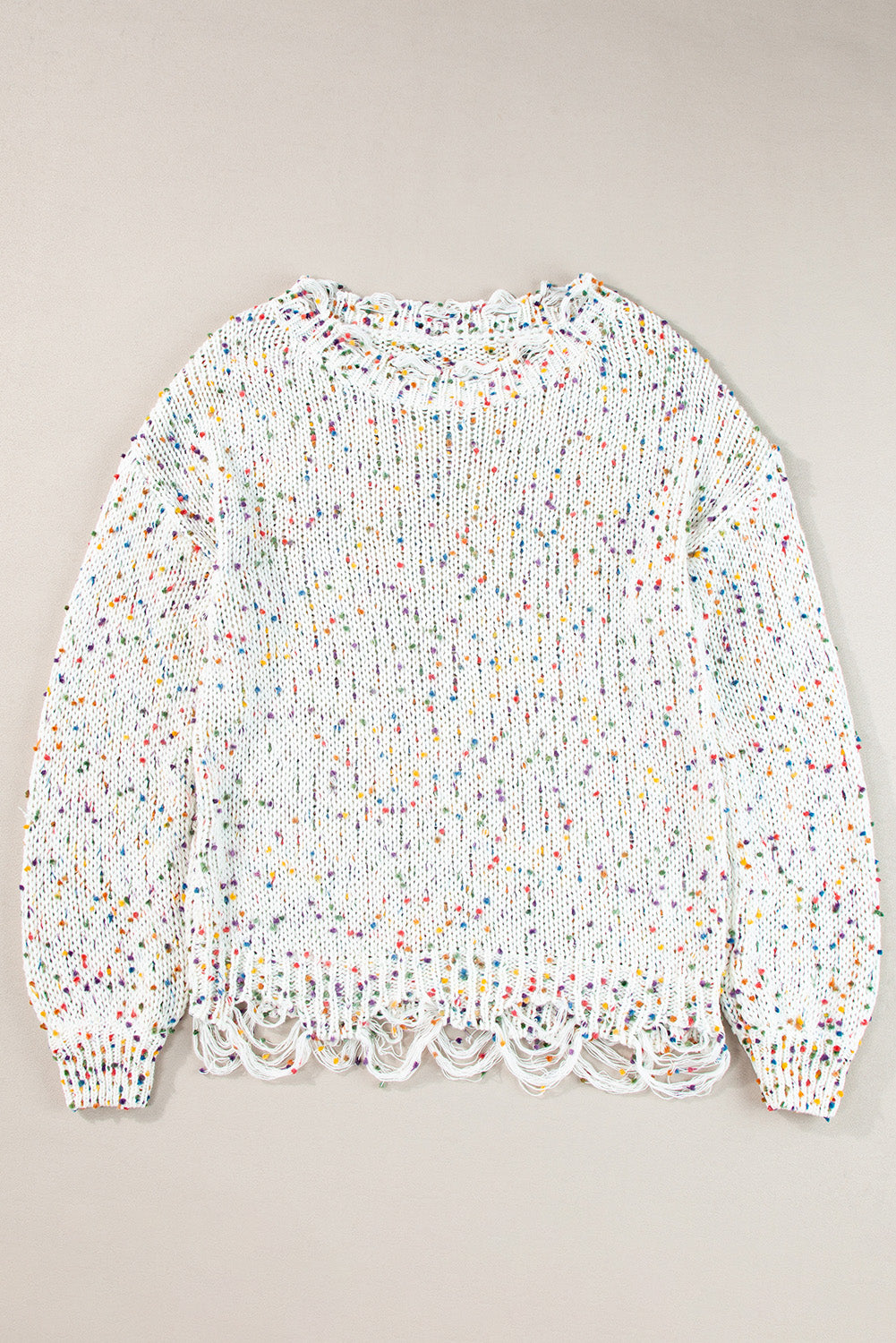 White confetti knit sweater with distressed hem and neckline.
