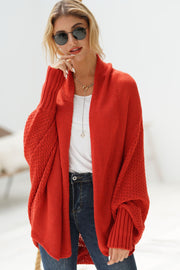 Red batwing knit cardigan with drape front and textured sleeves.