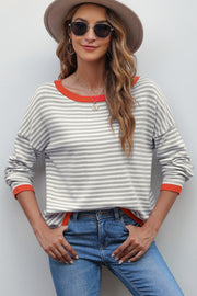 Nautical knit crewneck sweater with contrast trim in red and white stripes.