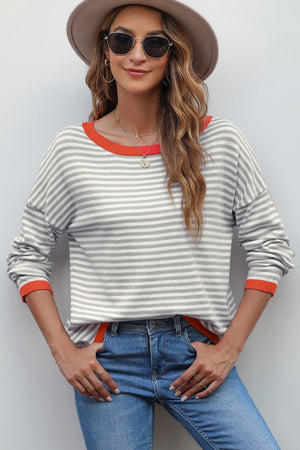 Nautical knit crewneck sweater with contrast trim in red and white stripes.