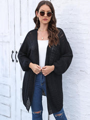 Black acrylic cable knit cocoon cardigan with open front and balloon sleeves.