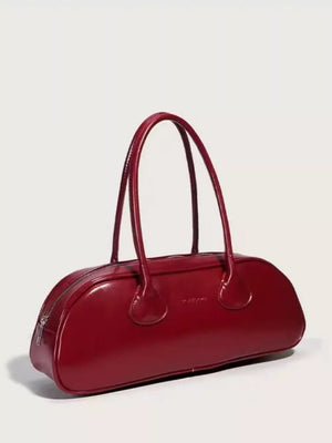 Chic red patent leather barrel shoulder bag with twin top handles and a zip closure.
