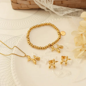 Gold balloon dog stud earrings and matching necklace and bracelet.