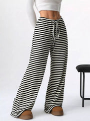 Striped ribbed wide-leg pants with drawstring waist and black and white pattern.