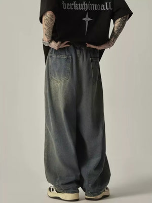 Relaxed fit blue vintage wash denim jeans with drawstring waist and back pockets.