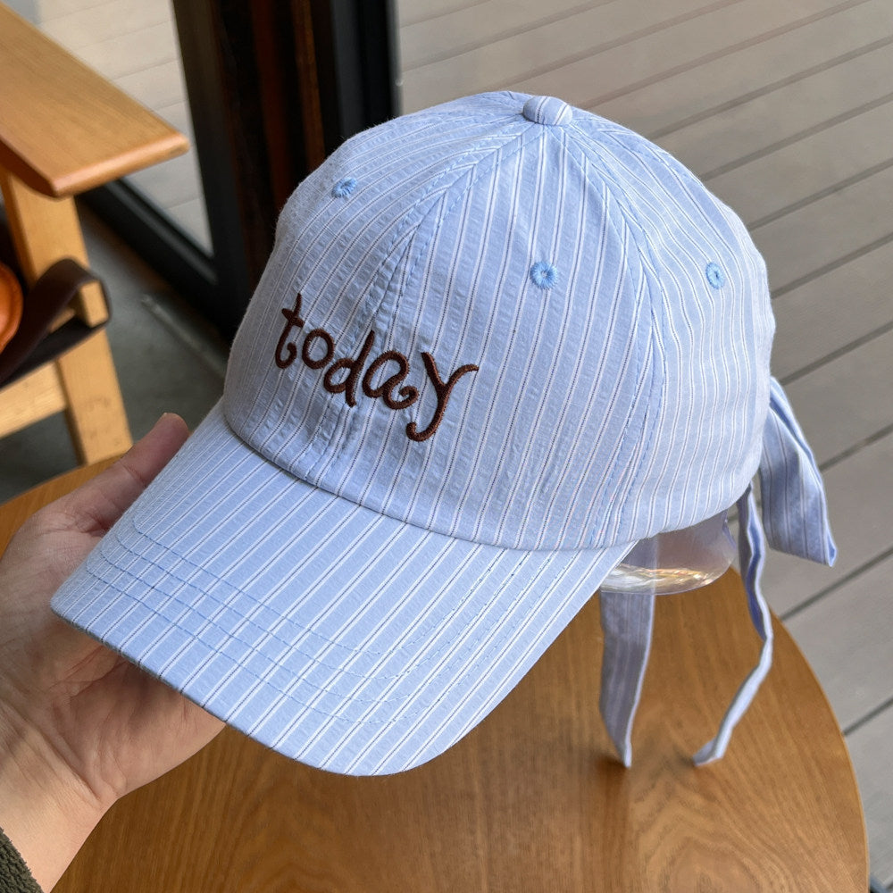 Pastel blue striped cotton baseball cap with embroidered "today" and tie back detail.