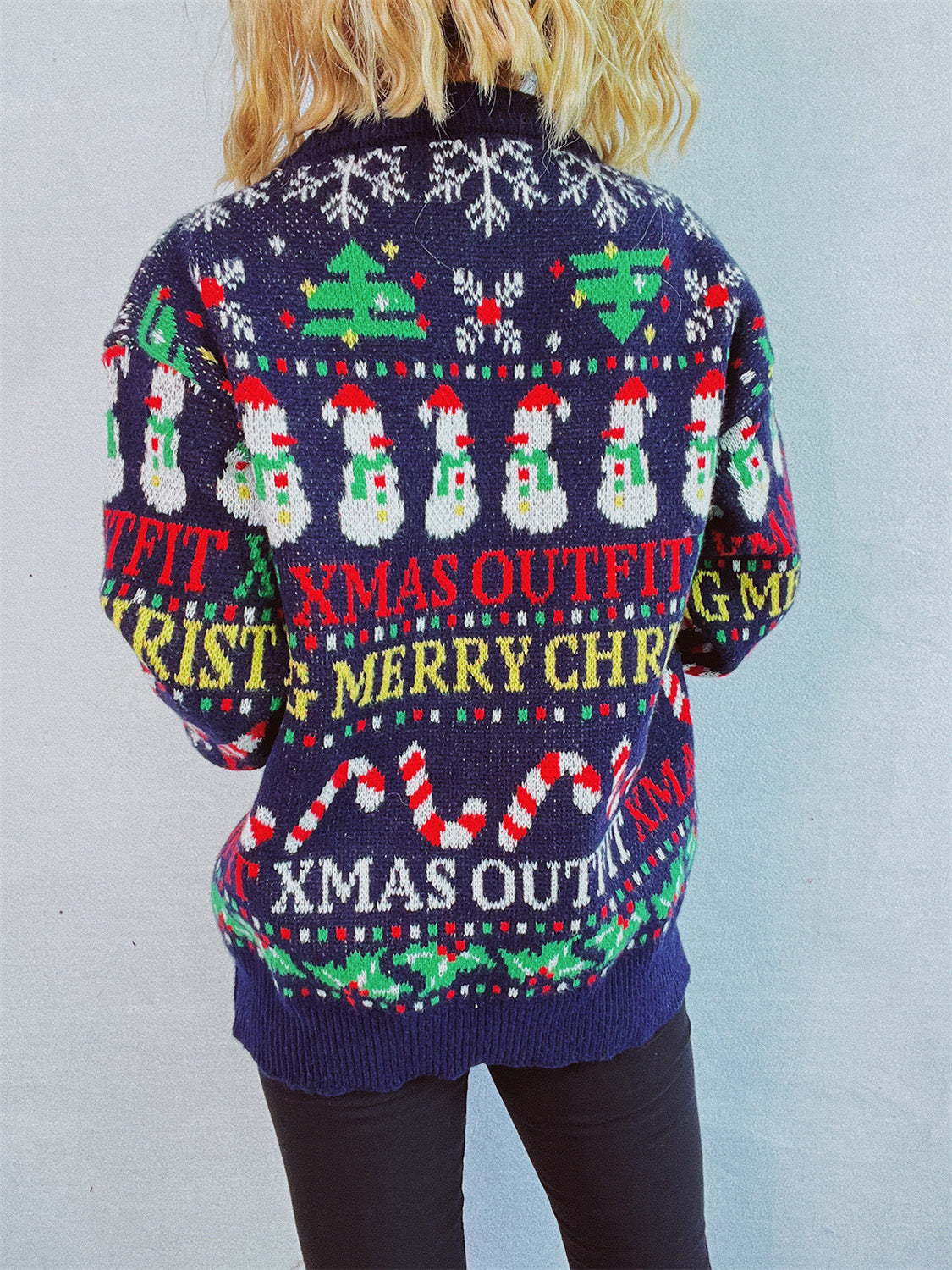 Dark blue acrylic knit sweater with Christmas graphic pattern, snowmen, candy canes, and text.
