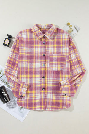 Oversized pink plaid flannel overshirt with button-down front and chest pocket.
