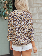 Print button-down shirt with leopard pattern, crew neck, and 3/4 sleeves.