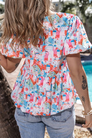 Watercolor village print peplum blouse with short puff sleeves and tiered hem.
