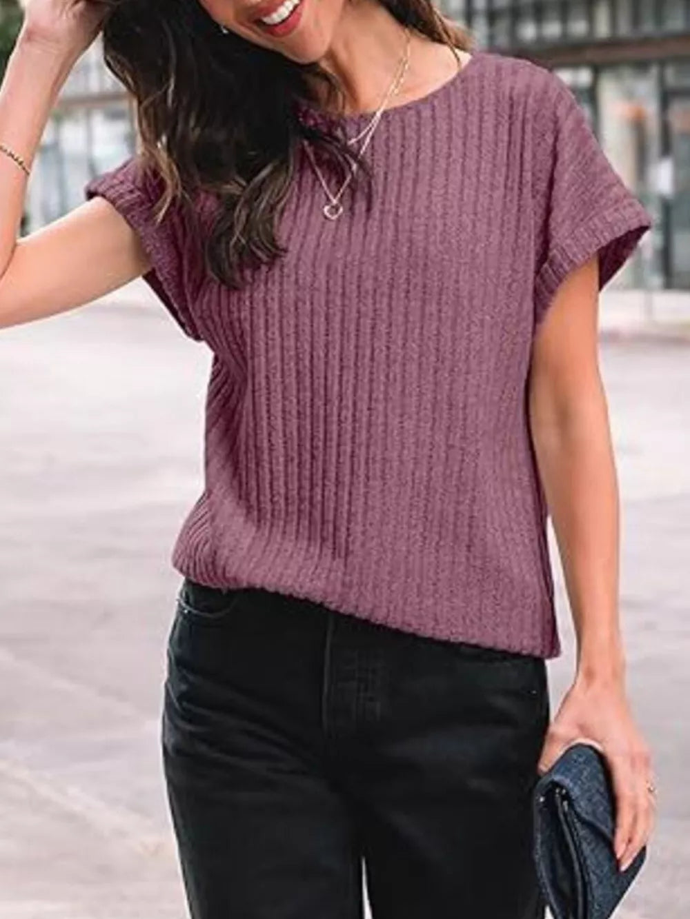 Purple red ribbed knit t-shirt with short sleeves and a crew neck, styled with black jeans.
