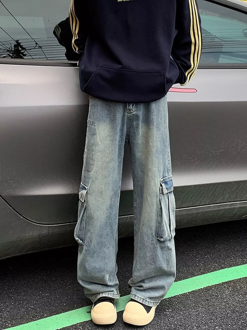 Men's vintage wash oversized cargo jeans with distressed detailing and multiple pockets.