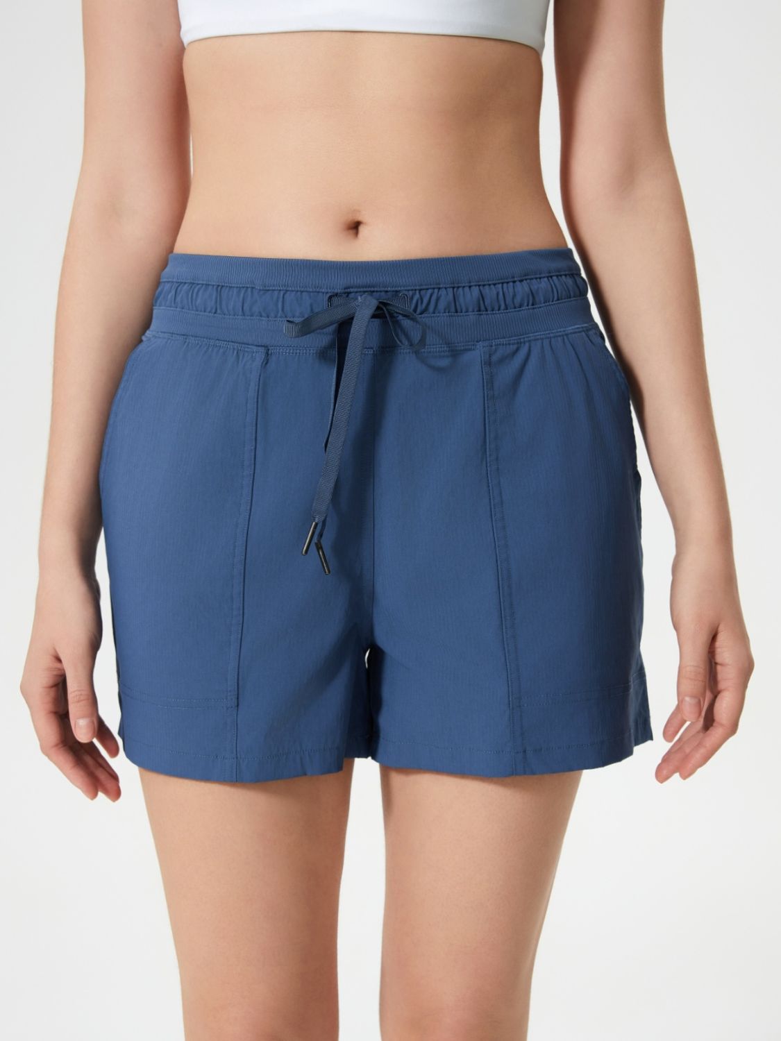 Coastal drawstring utility shorts in dusty blue with elastic waistband and tie.