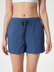 Coastal drawstring utility shorts in dusty blue with elastic waistband and tie.