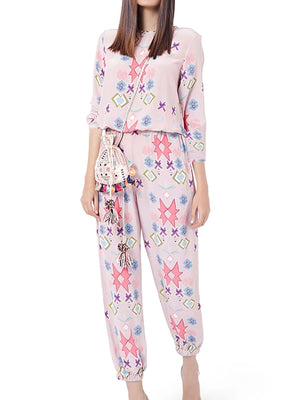 Women's blush pink abstract print lounge set with crew neck top and elastic waist pants.