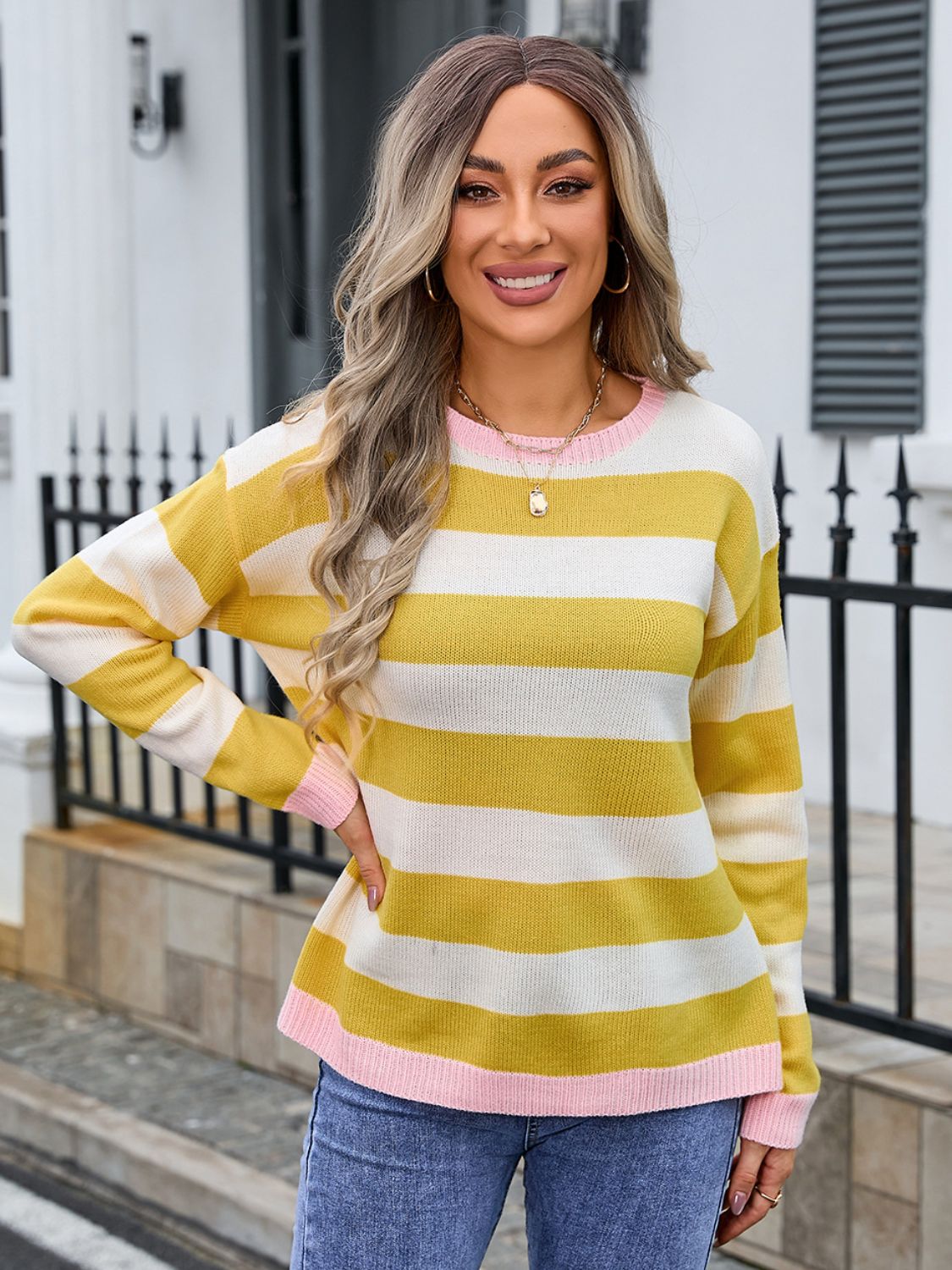 Striped acrylic sweater in yellow and white with pink trim and cuffs.