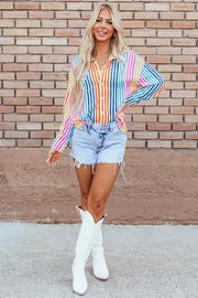 Rainbow stripe relaxed fit button-down shirt with a collared neckline and long sleeves.