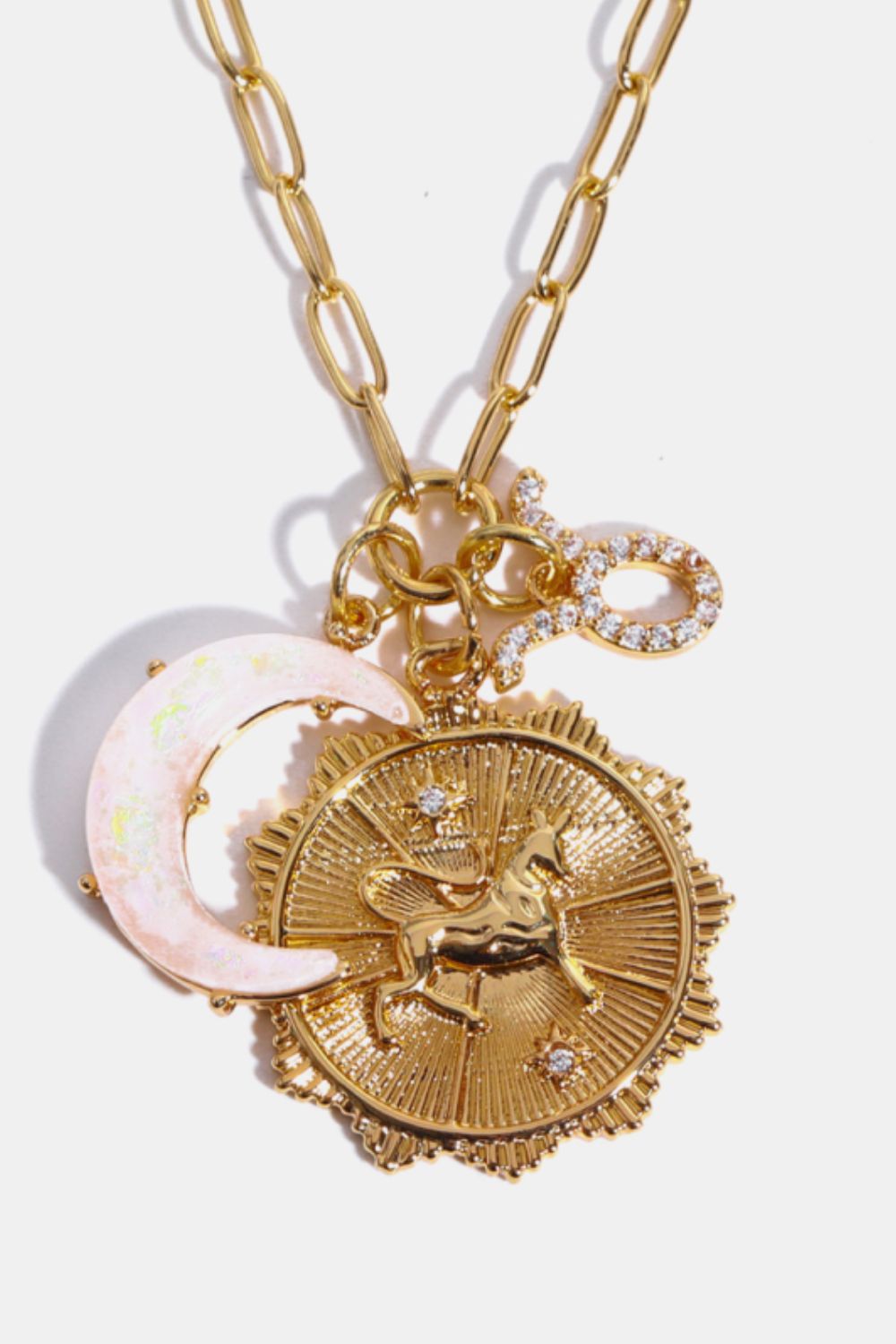 Gold celestial pendant necklace with unicorn, moon, and zodiac symbol charms.