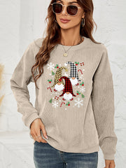 Beige corduroy sweatshirt with a gnome graphic featuring buffalo check, leopard print, and snowflakes.