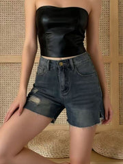 Frayed hem distressed denim shorts in dark wash with button closure and side slits.