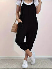 Black loose fit spaghetti strap jumpsuit with pockets and cuffed ankles.