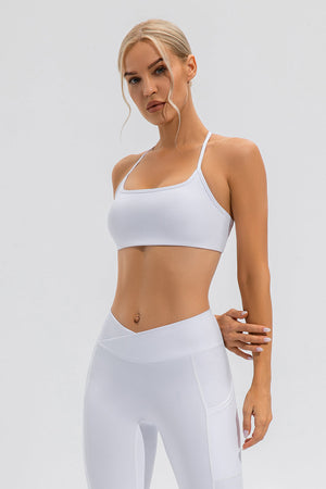 White sports bra with thin crisscross back straps and square neckline.