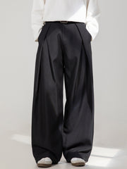 Men's black wide-leg trousers with pleats and a belt.