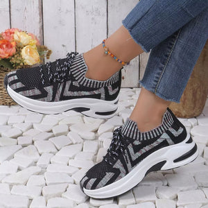 Geometric knit platform sneakers in black with white and grey zigzag pattern.