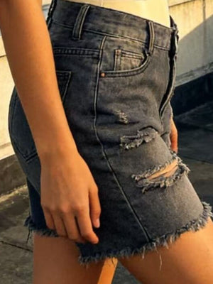 Distressed denim shorts in dark blue with frayed hem and ripped details.