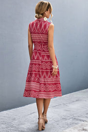 Deep Red sleeveless midi dress with geometric print, A-line cut, and tiered skirt.