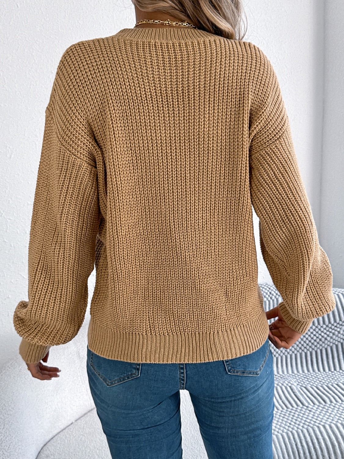 Camel acrylic sweater with chevron knit detail and balloon sleeves.