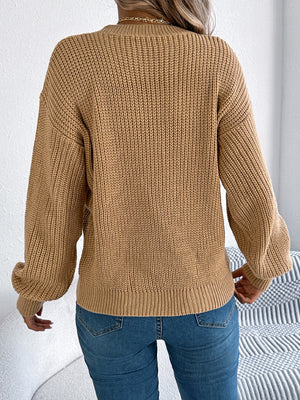 Camel acrylic sweater with chevron knit detail and balloon sleeves.