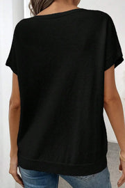 Black knit tunic t-shirt with short sleeves and a ribbed hem.