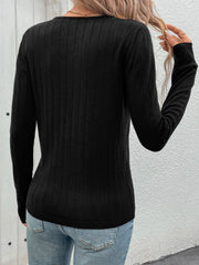 Black ribbed V-neck knit sweater with long sleeves.