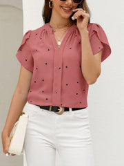 Dusty pink heart print blouse with puff sleeves and v-neck.