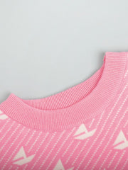 Blush pink knit sweater with sailboat jacquard pattern and ribbed crewneck.