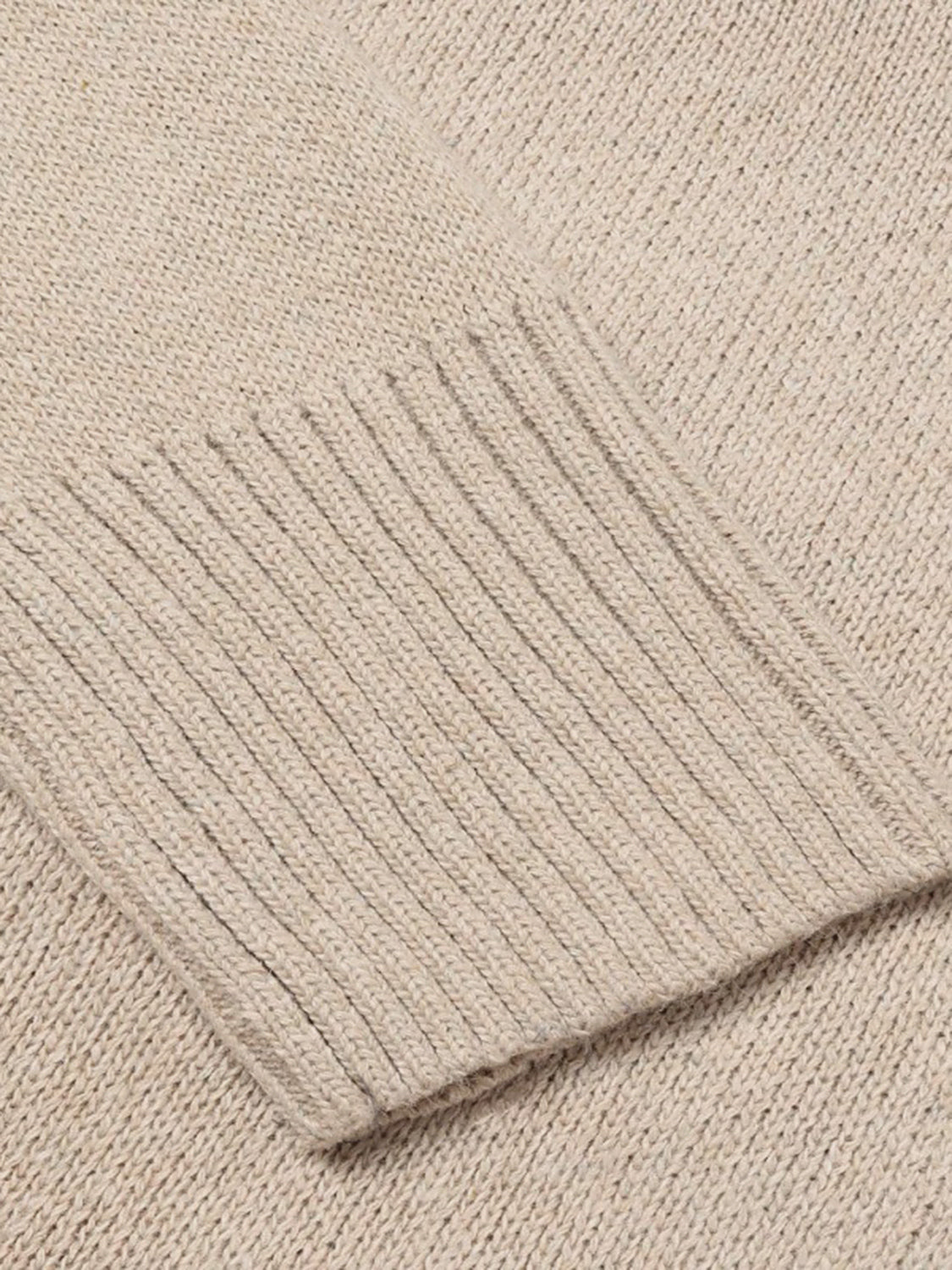 Tan knit sweater with ribbed trim detail on cuff.