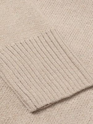Tan knit sweater with ribbed trim detail on cuff.