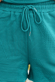 Turquoise textured co-ord short set with drawstring waist and chevron pattern detail.