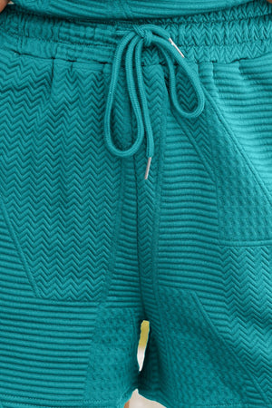 Turquoise textured co-ord short set with drawstring waist and chevron pattern detail.