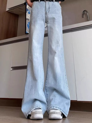 Light blue distressed full-length flare jeans with a cotton blend fabric.