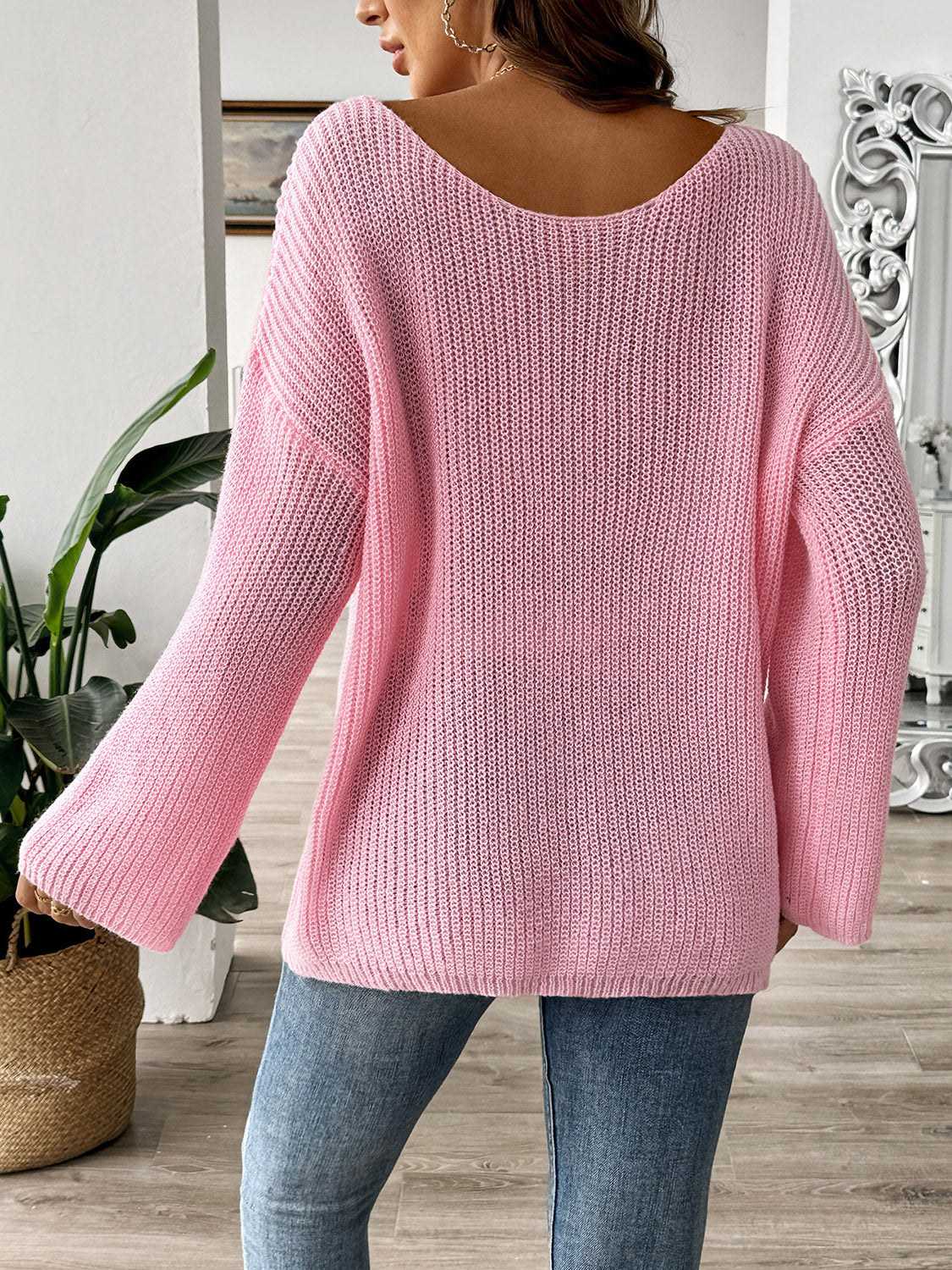 Blush pink knit sweater with boatneck and long sleeves, featuring a textured knit pattern.
