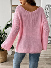 Blush pink knit sweater with boatneck and long sleeves, featuring a textured knit pattern.