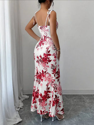 Maxi dress with tie straps, white with a bold red floral print, fitted silhouette.