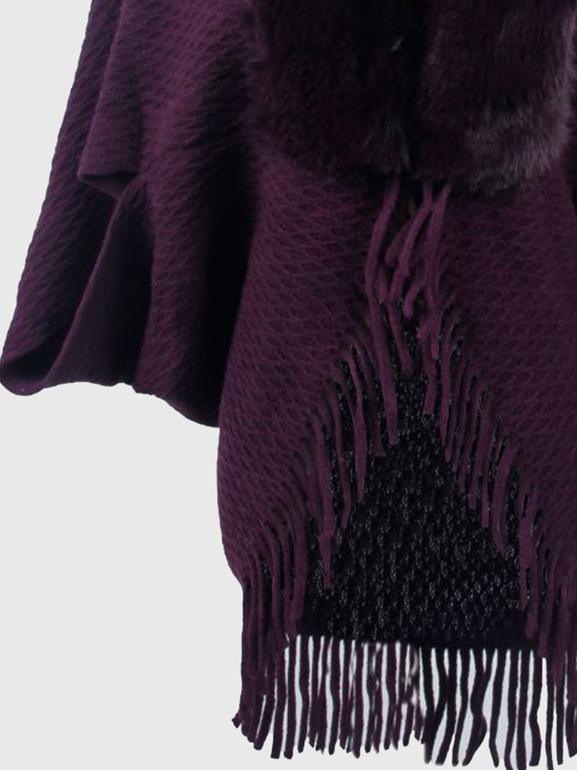 Plum textured knit poncho with faux fur collar and fringe detail