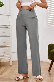 Gray high-waisted flare leg trousers with pockets, styled casually.