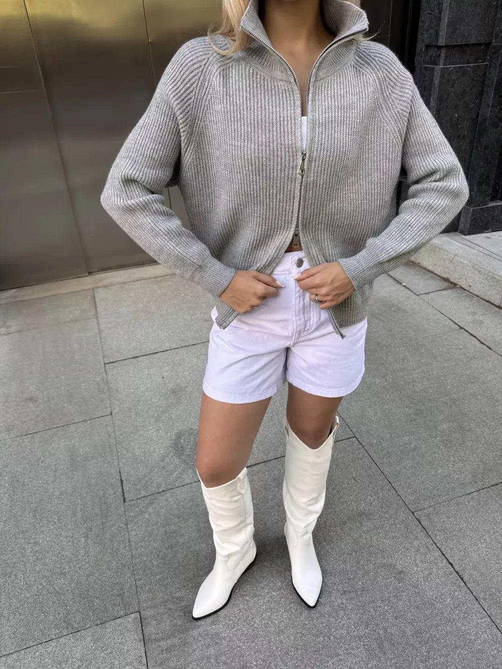 Gray ribbed knit zipper cardigan with a stand-up collar and full zip closure.