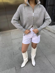 Gray ribbed knit zipper cardigan with a stand-up collar and full zip closure.