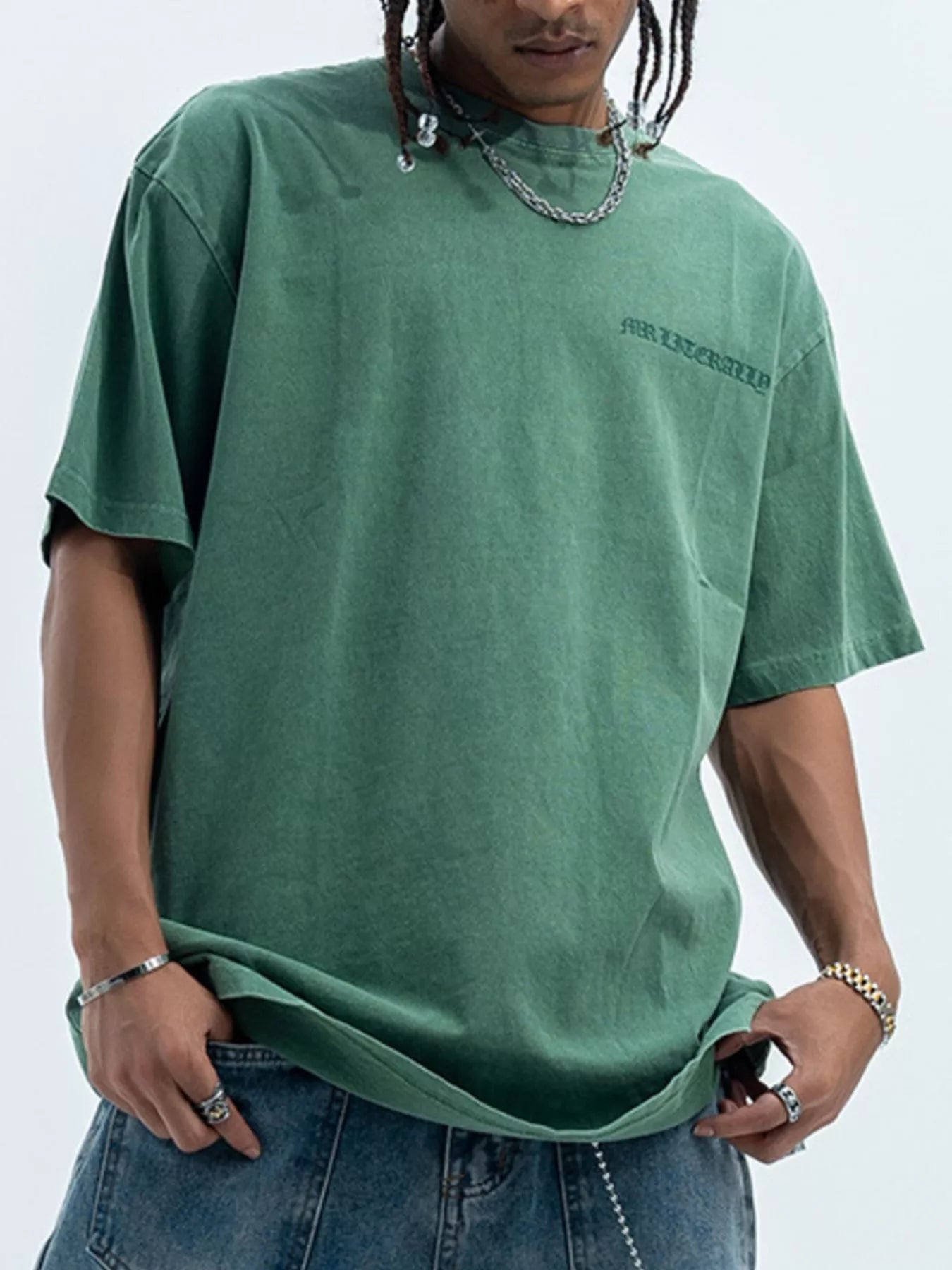 Green oversized graphic tee, 100% cotton, with a subtle front graphic and relaxed fit.