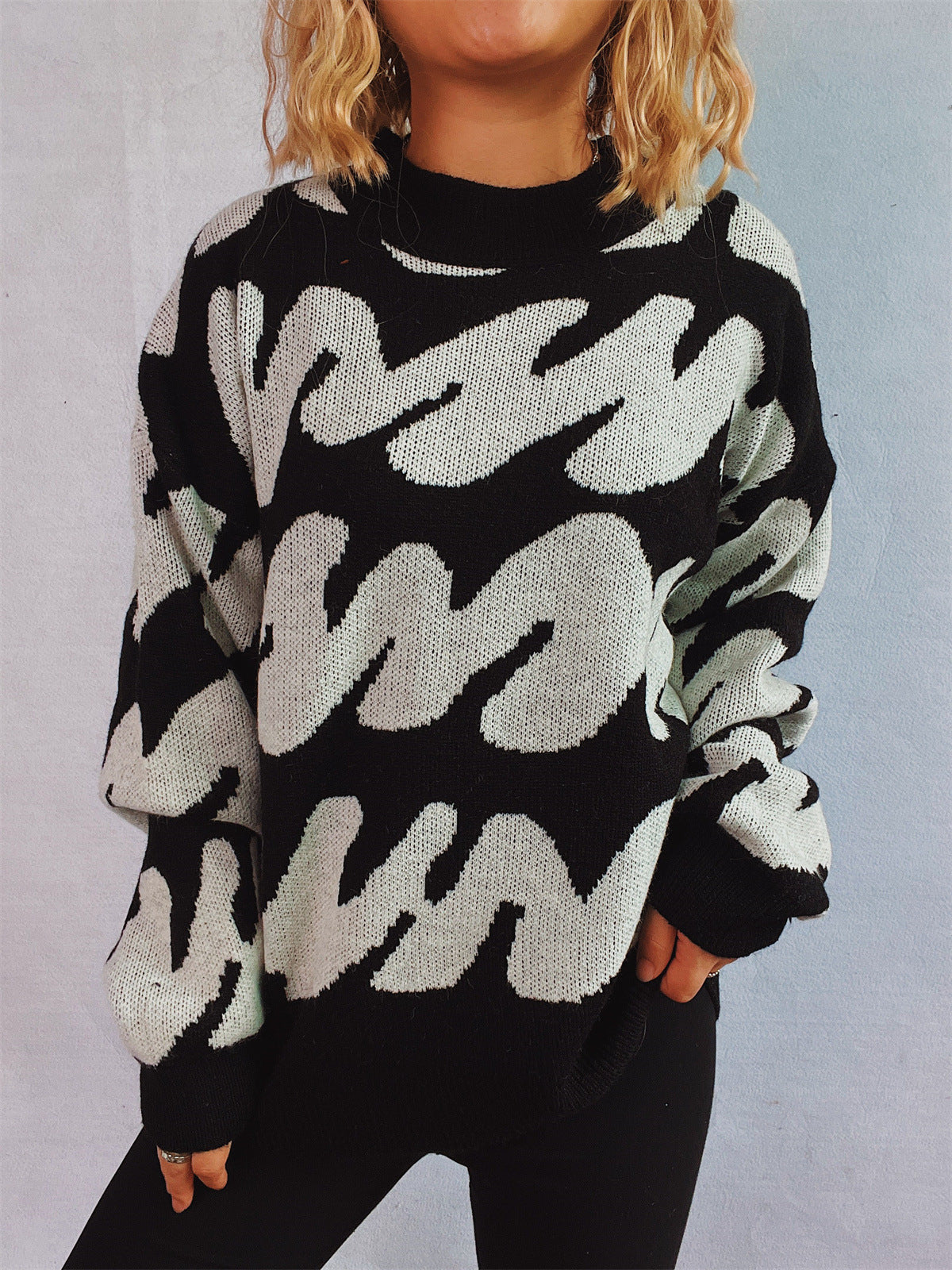 Graphic Wave Knit Sweater in black and white, with a mock neck and long sleeves.